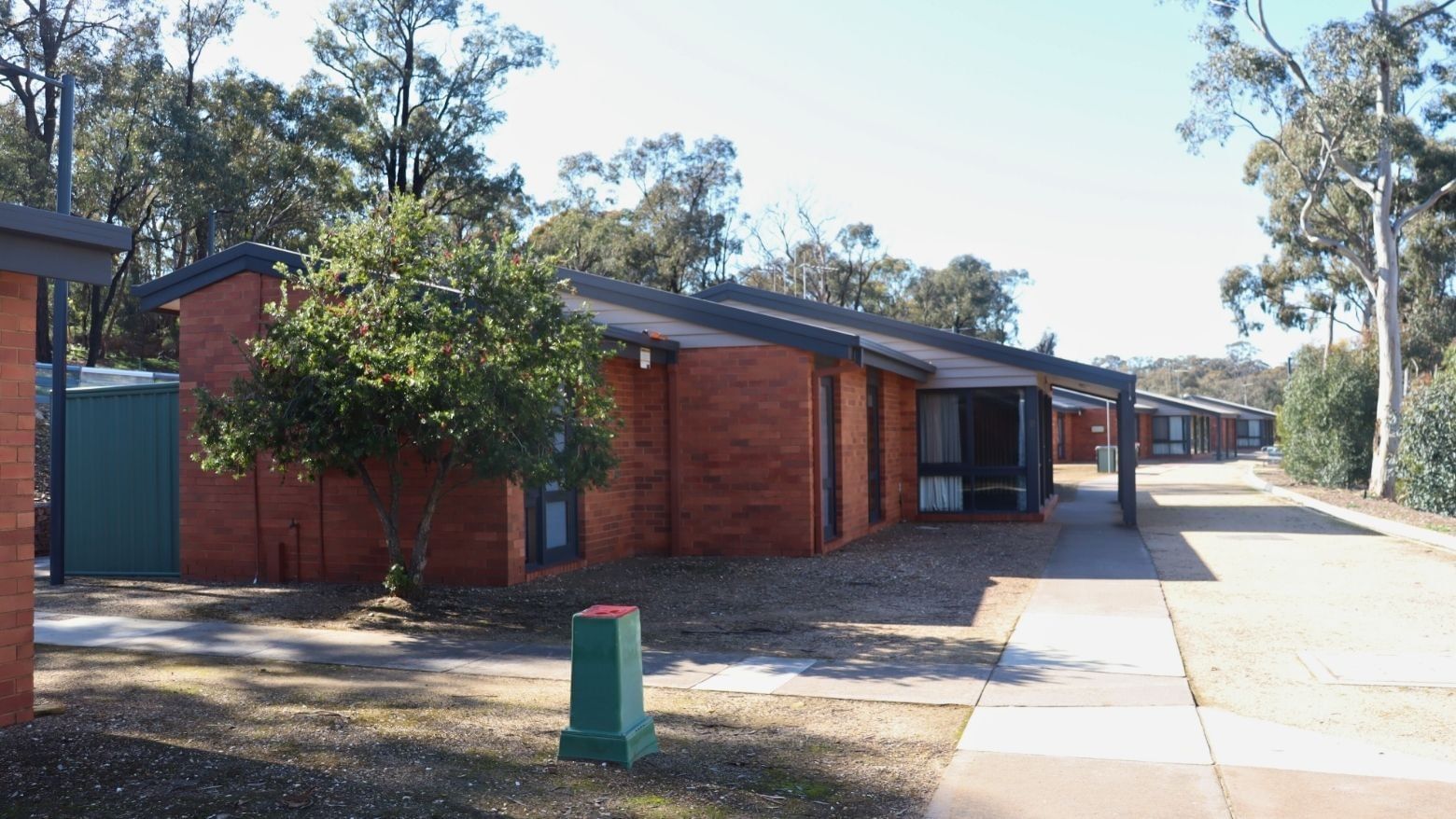 Row of brick units with tree and walkway in front at La Trobe University - Terraces.