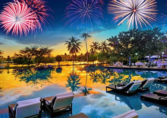 Fireworks lighting up the sky over the outdoor pool area at The Danna Langkawi