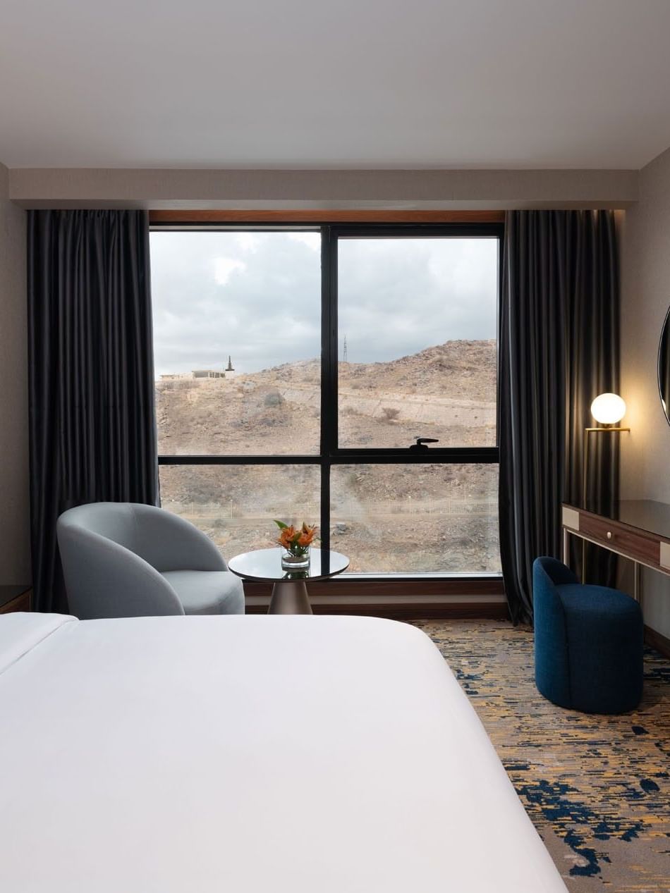 Vanity table facing the bed with a couch near window in Royal Suite at Warwick Al Taif Hotel