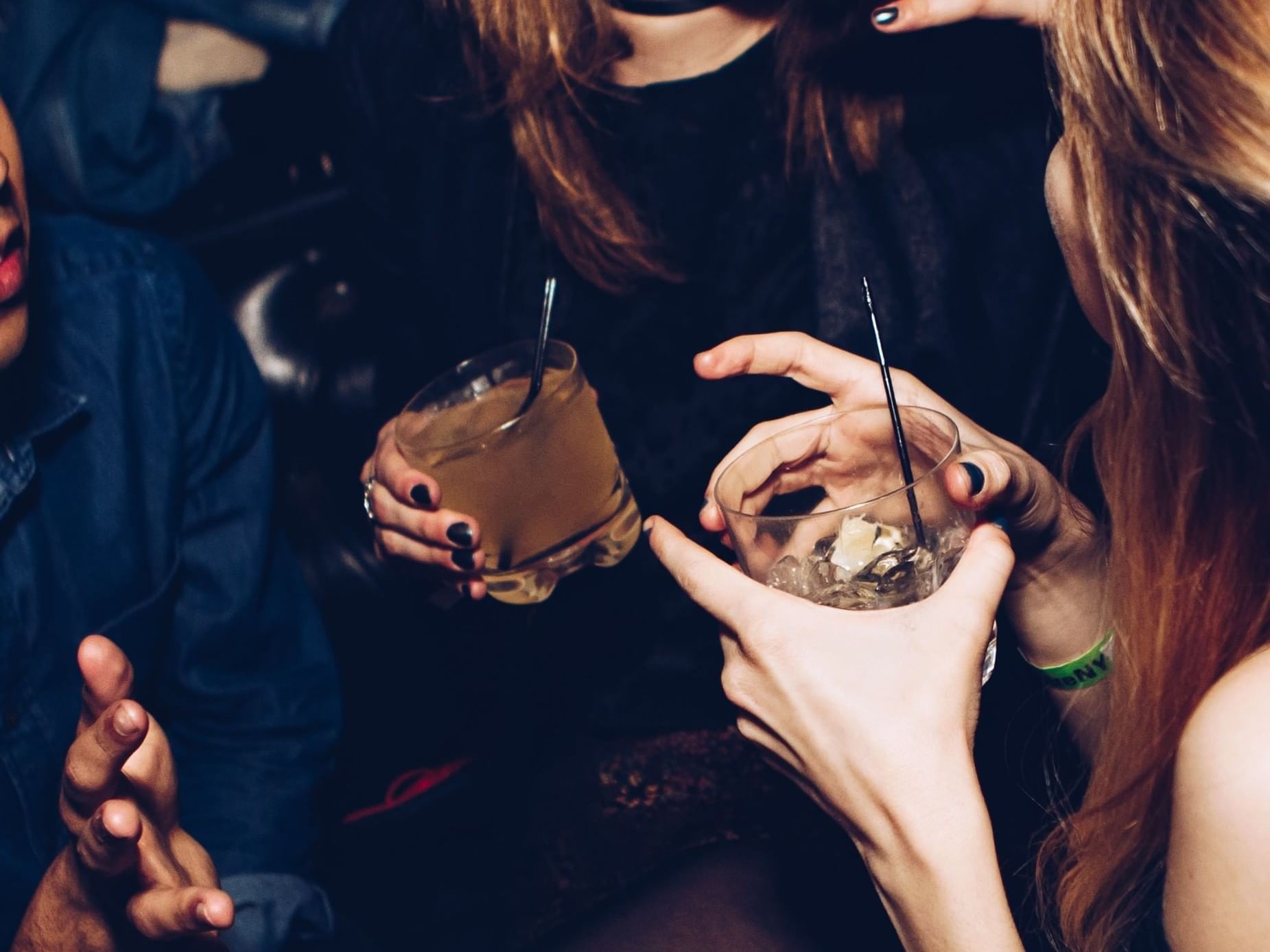 three people drinking mixed drinks