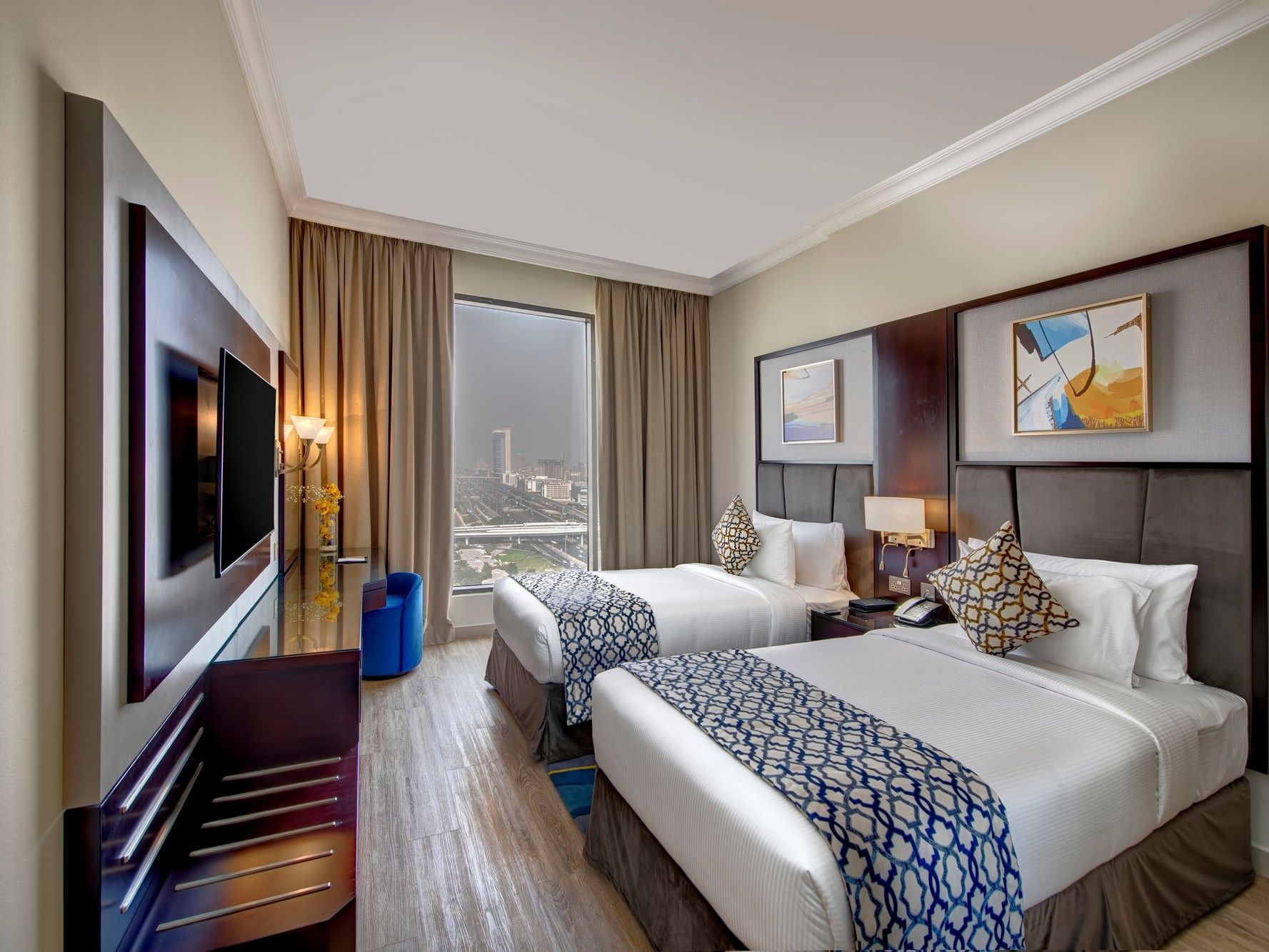 Two Bedroom Apartment City View at Two Seasons Hotel & Apartments Dubai with two beds and a large window.