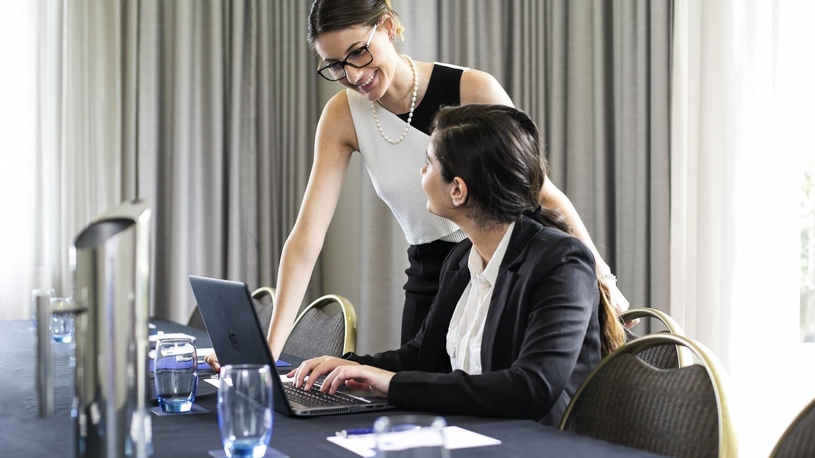Two ladies discussing in the meeting room at the Sebel Residence Chatswood