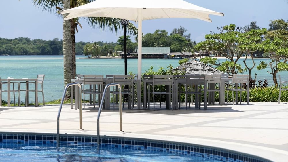 Pool with umbrella and chairs at Warwick Le Lagon - Vanuatu, Efate.