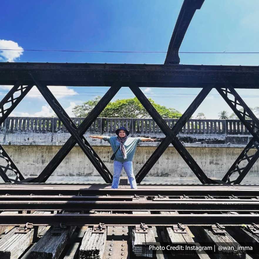 A woman was striking a pose on the Ipoh Victoria Bridge - Lexis Suites Penang