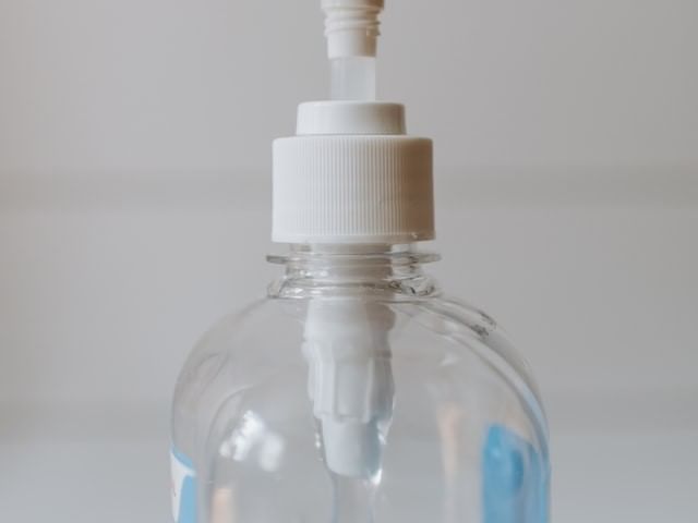 Close-up of a sanitizer bottle at La Galerie Hotel