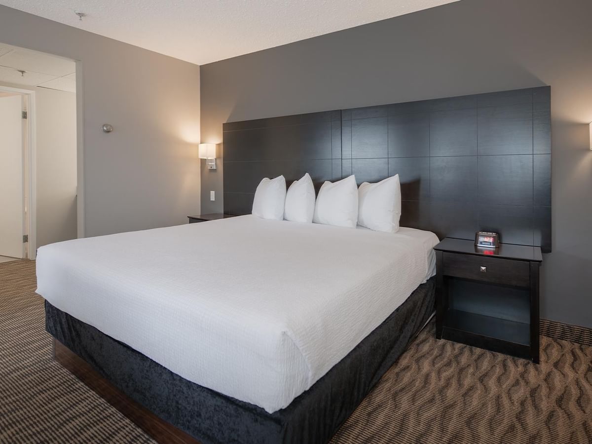 Hotel suite bedroom with a king bed.