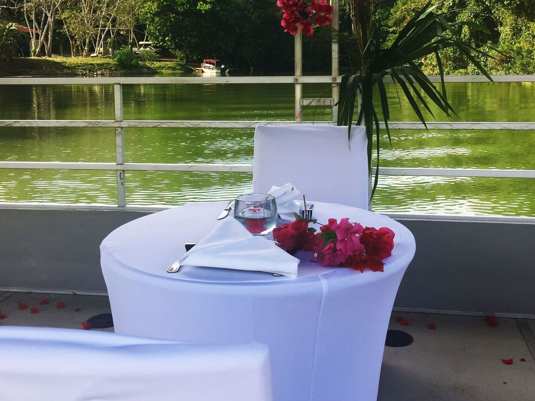 Lakeside dinner table with flowers at Gamboa Rainforest Resort