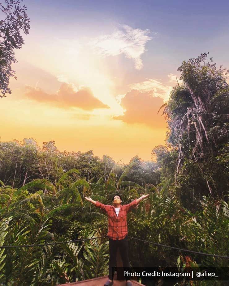 A man was taking a picture at the Matang Mangrove Forest Reserve Eco Park - Lexis Suites Penang 