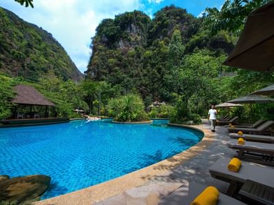 Sunbeds by the outdoor pool area at The Banjaran Hotsprings Retreat