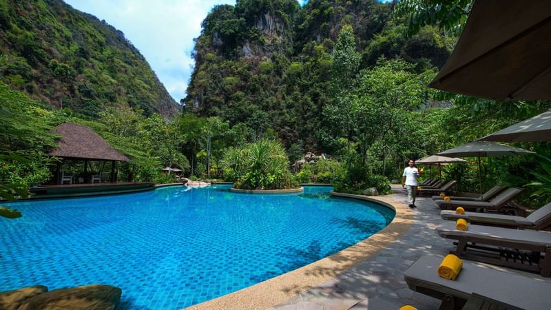 Sunbeds by the outdoor pool area at The Banjaran Hotsprings Retreat
