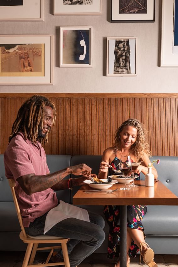 Couple enjoying meals with some wine at The Rockaway Hotel