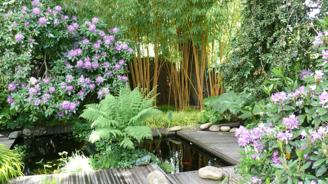 A small pond at Le Jardin Retire garden near Originals Hotels