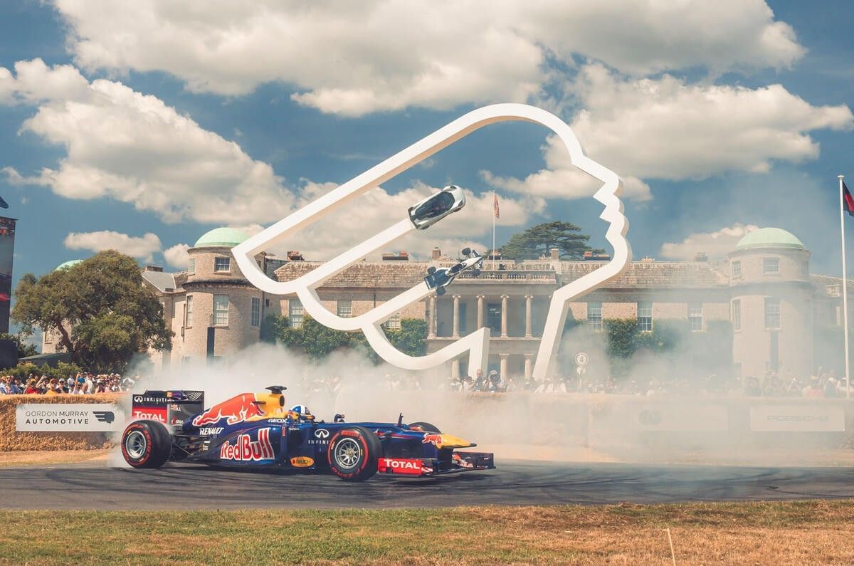 Goodwood Festival of Speed artwork near The Londoner Hotel, featuring a racing car drifting past a large monument