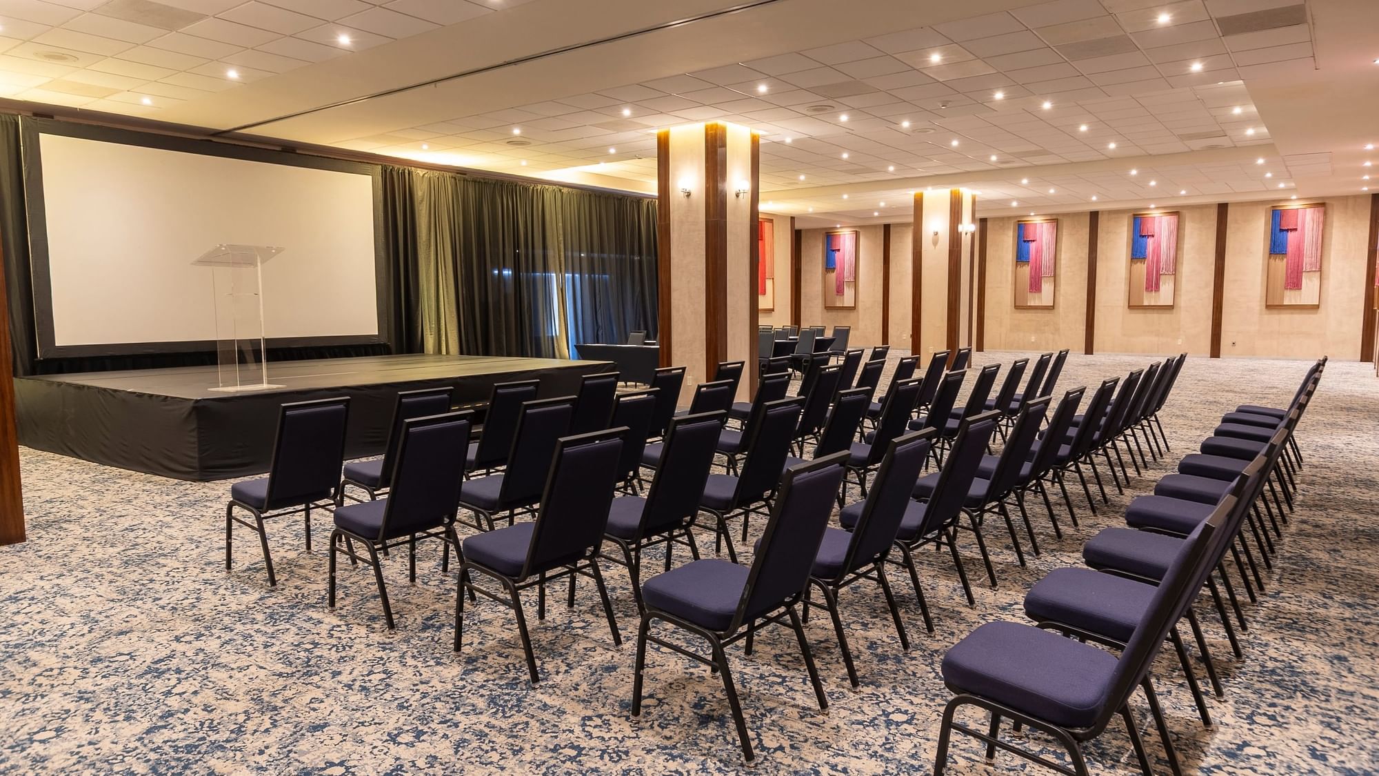 Sala de reuniones con muchas sillas y pantalla en el Fiesta Americana Riviera Nayarit Resort & Spa.