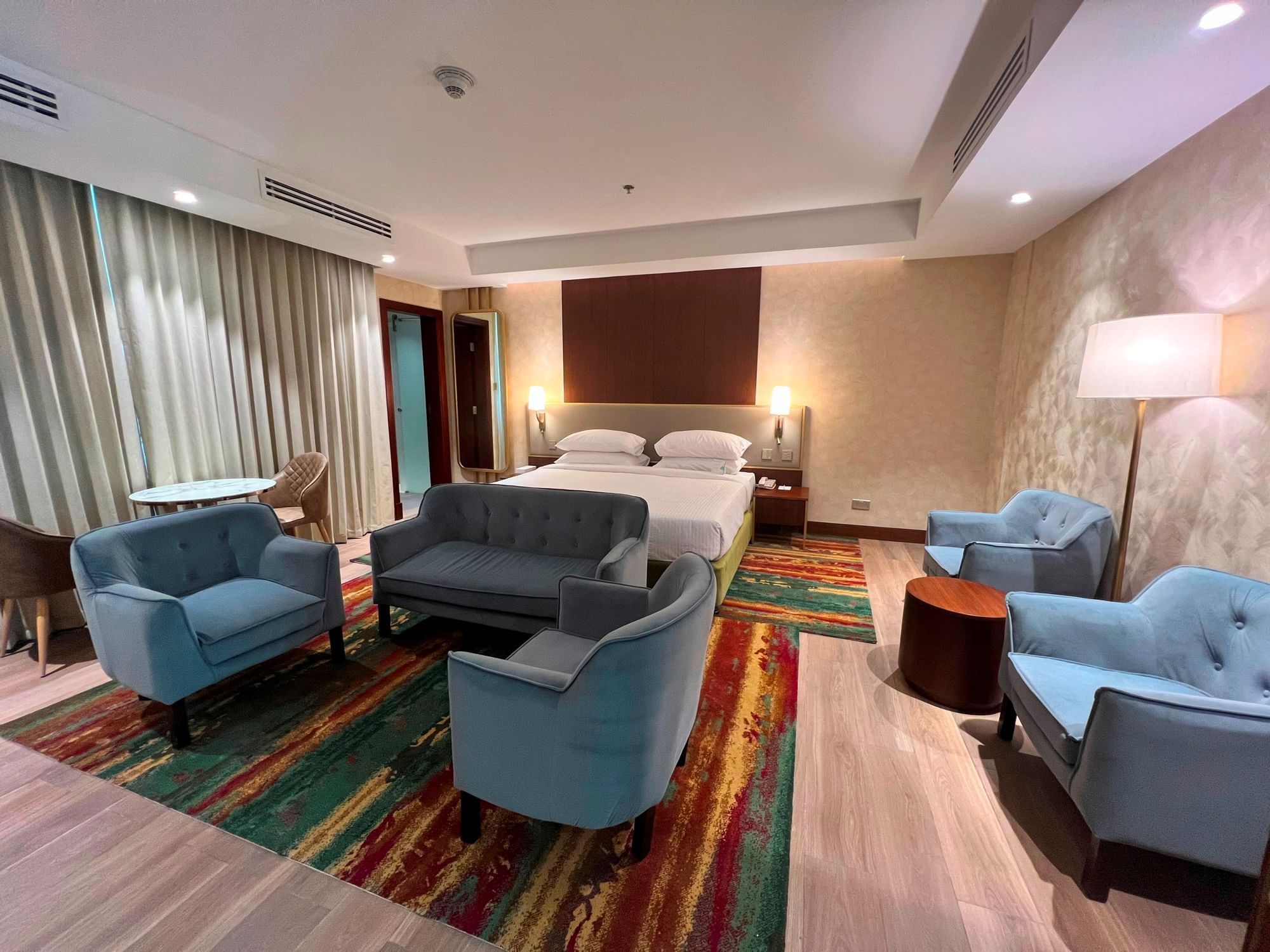 Bed & living area in Boutique Studios at City Seasons Hotels