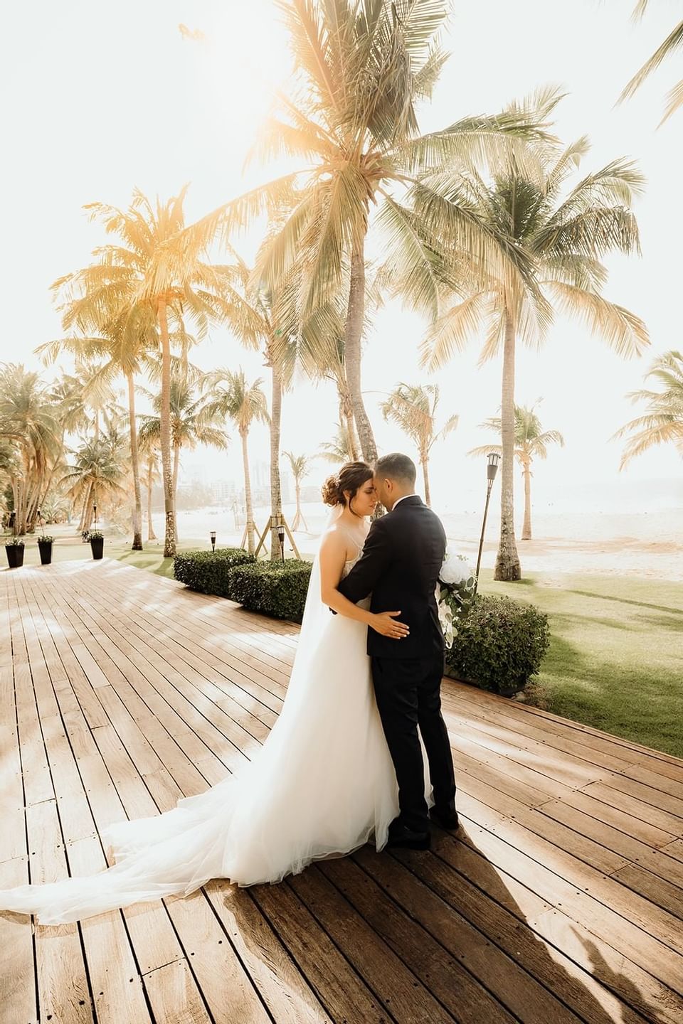 Bride & Groom posing on a deck at Isla Verde Weddings