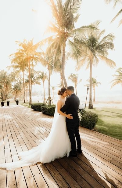 Bride & Groom posing on a deck at Isla Verde Weddings