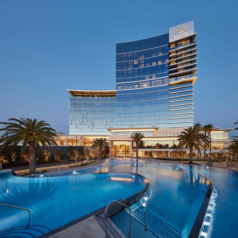 Low angle shot of a pool and front façade of Crown Towers Perth