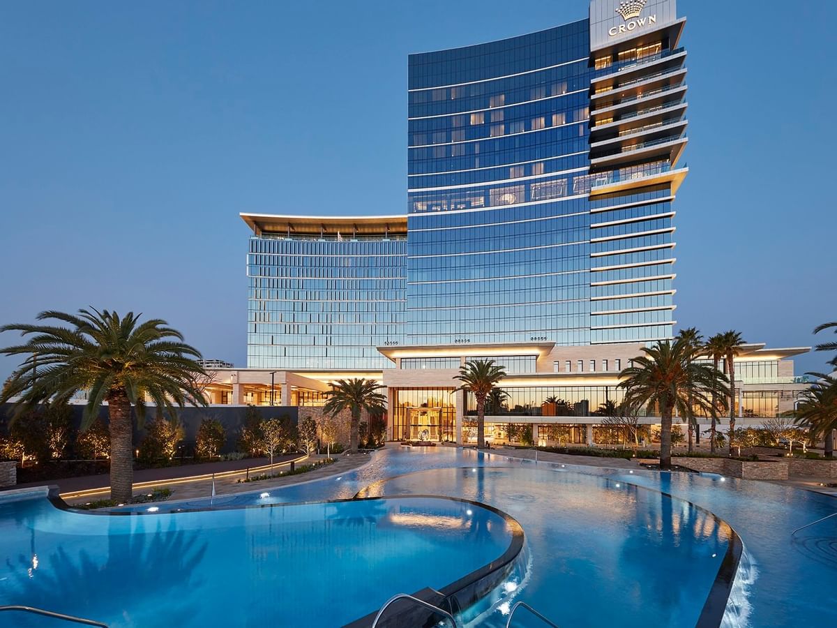 Low angle shot of a pool and front façade of Crown Towers Perth
