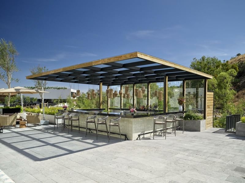 Outdoor pool bar with loungers at Live Aqua Urban Resort San Miguel de Allende