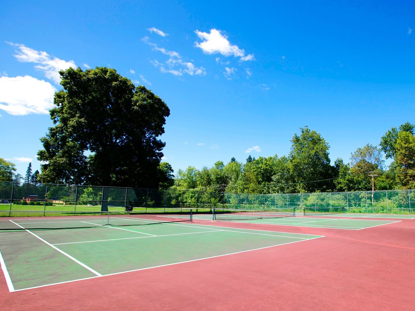 Day view of outdoor tennis court at Honor’s Haven Retreat