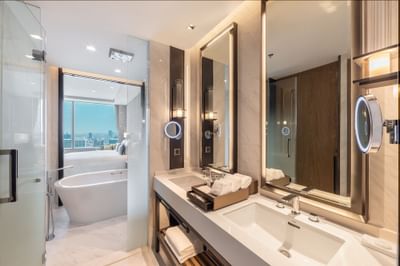 Bathroom vanity with amenities & smart mirrors in a room at Eastin Grand Hotel Phayathai