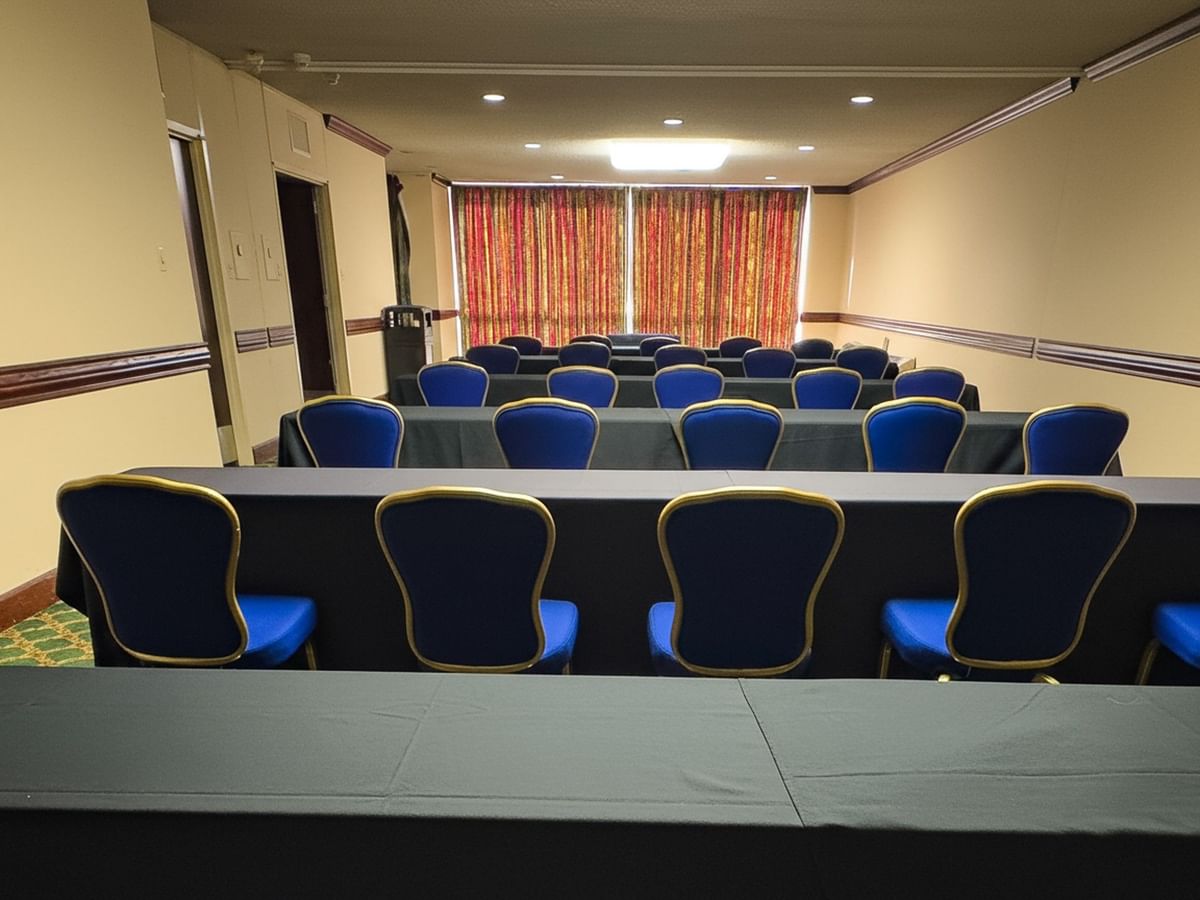 Tower Suites with rows of blue chairs, black tables and colorful curtains at Arlington Resort Hotel & Spa