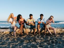 5 People eating watermelon on the beach near The Rockaway Hotel