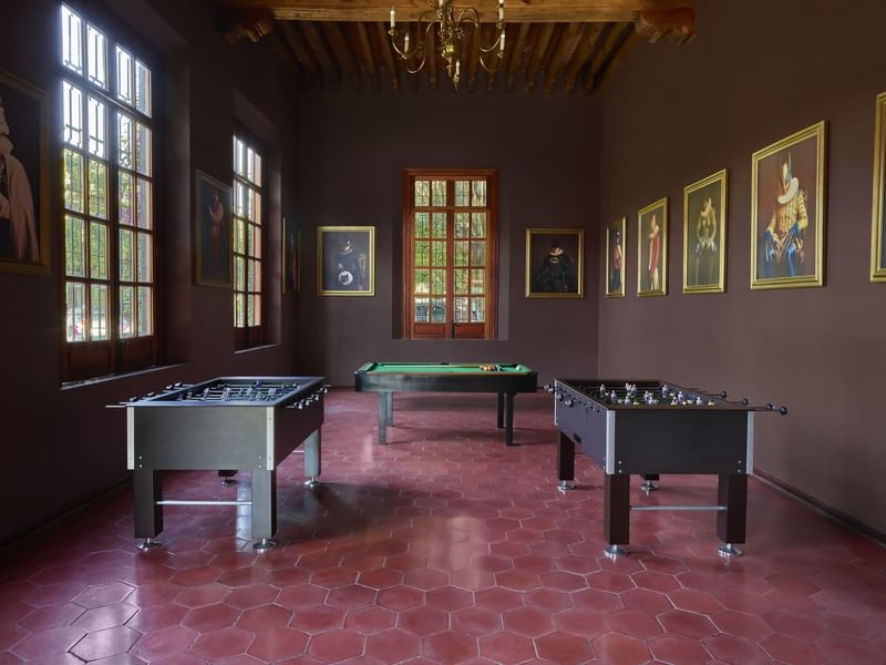Game room with paintings & pool tables at La Colección Resorts