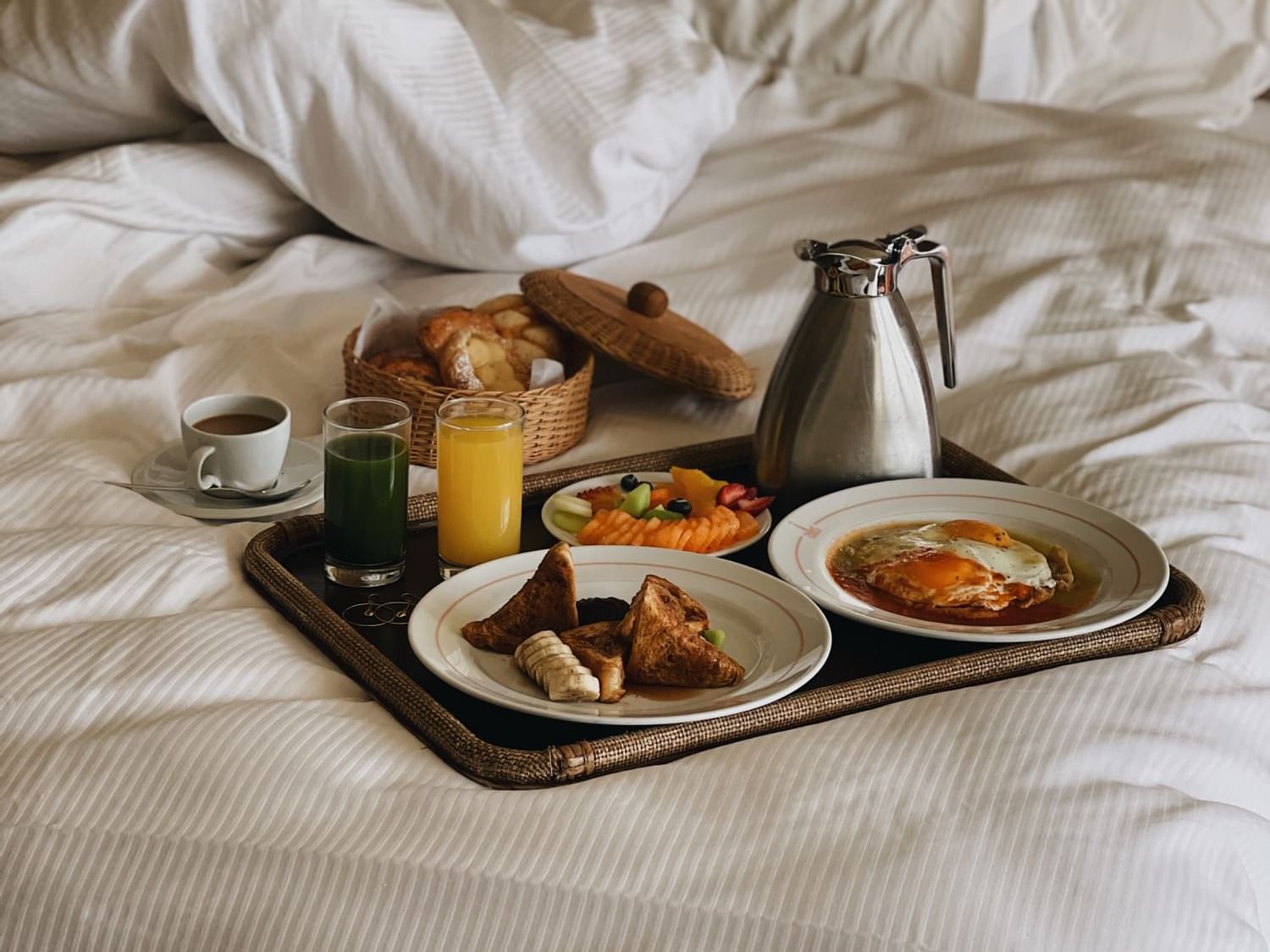 Closeup of a continental breakfast on a bed at Los Cabos