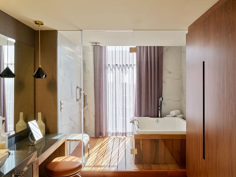 Bathroom with bathtub & wooden floors in Presidential Suite at Fiesta Americana