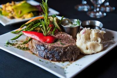 Filet with potatoes and fresh vegetables.