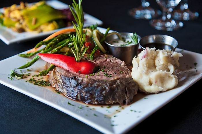 Filet with potatoes and fresh vegetables.