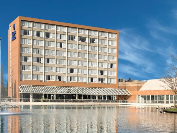 Exterior of Coast Chilliwack Hotel by APA with pond