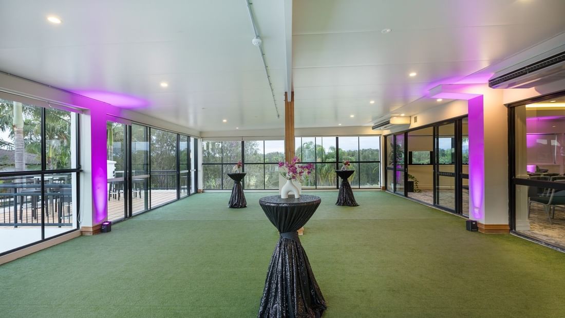 The Club Room event space with large windows and purple lighting at Mercure Gold Coast Resort in Carrara.