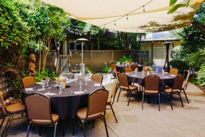 Banquet tables arranged in The Grove at Dinah's Garden Hotel