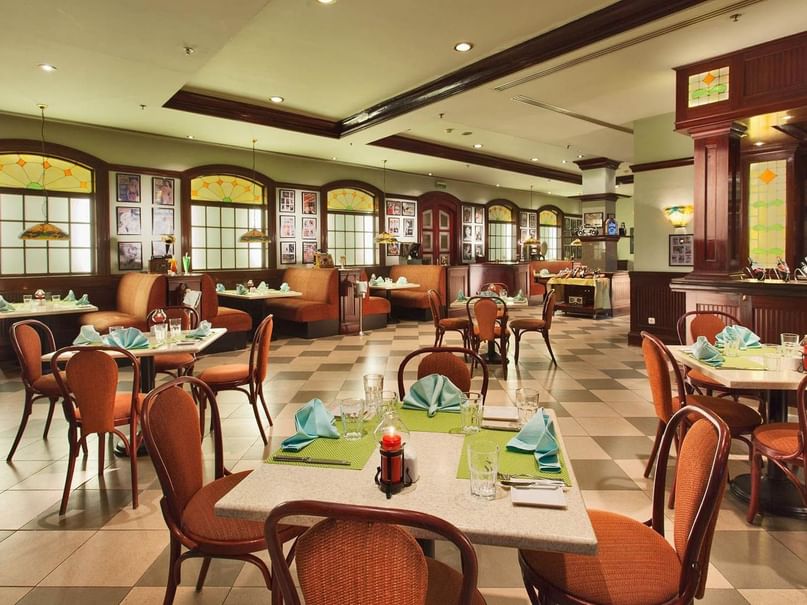 Mezze Restaurant with tables set for dining, cutlery & a candle centerpiece on each at Pickalbatros Golf Beach Resort