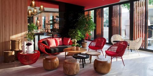 Lounge area with red cane chairs at Eastin Hotels