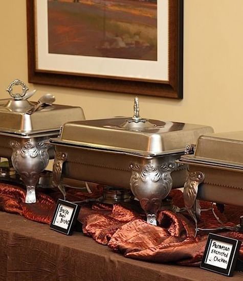 Buffet table arranged with silver chafers trays at The Wildwood Hotel