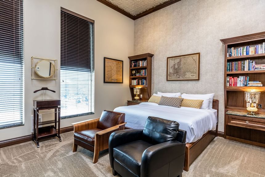 Large bed, bookshelves & comfy chairs in King Premiere Library at Retro Suites Hotel