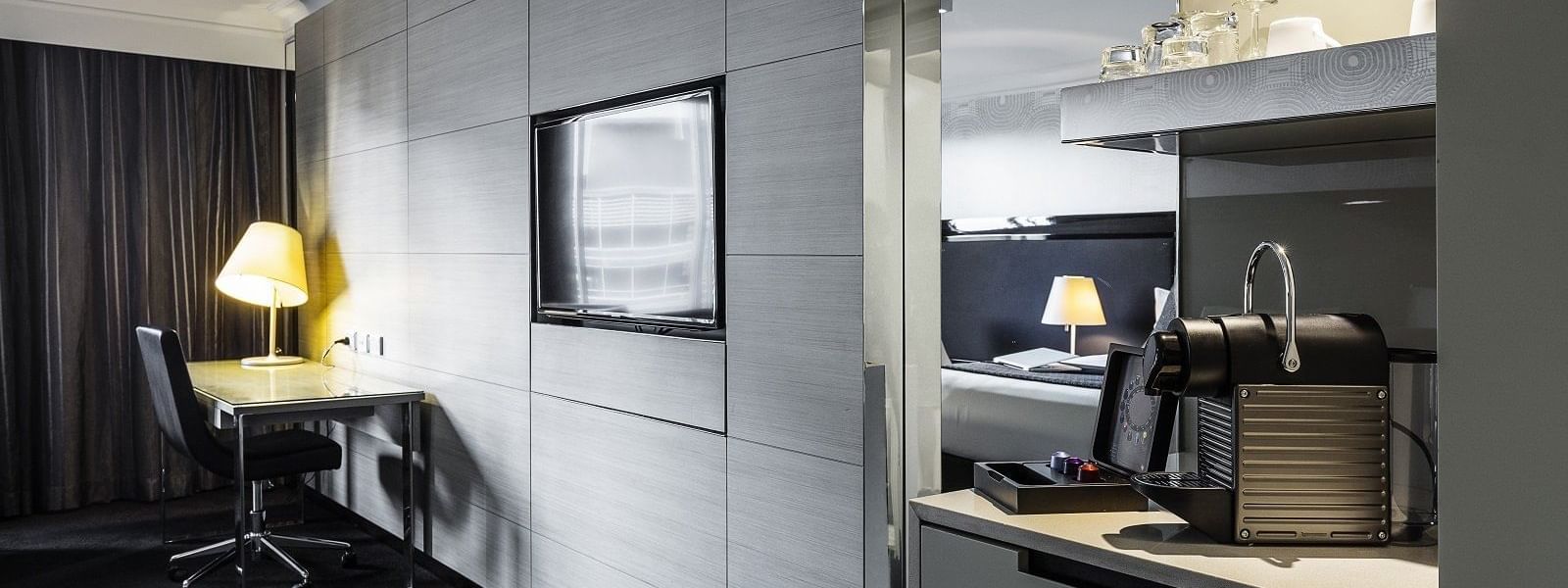Sleek Nespresso machine and flat-screen television in the Executive Room at Pullman Brisbane King George Square