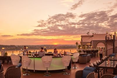 Bartenders arranging Skybar at Eastin Hotels captured during sunset