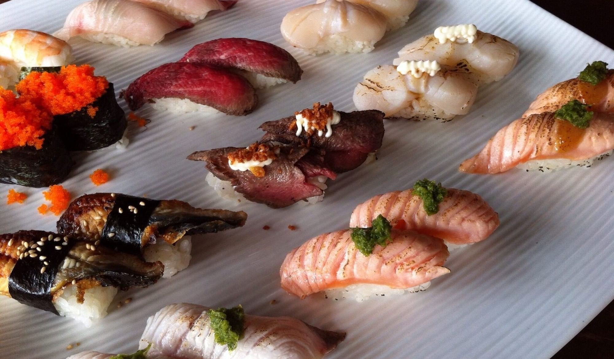 Diverse platter at Elysium Hotels includes sushi options like aburi salmon, seared wagyu beef and various seafood