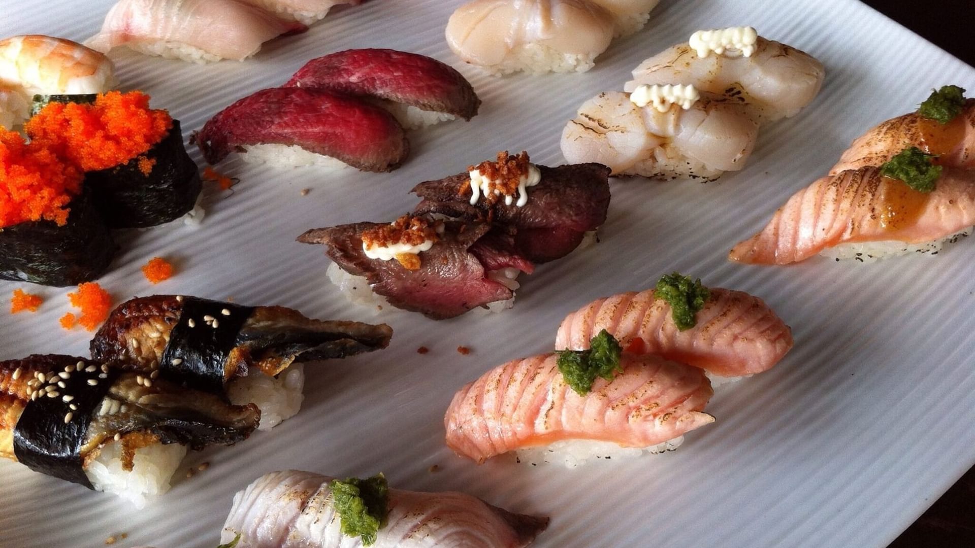 Assorted nigiri sushi arranged in neat rows on a white ceramic platter in Shushi Waka at Elysium Manly, best hotels in Manly