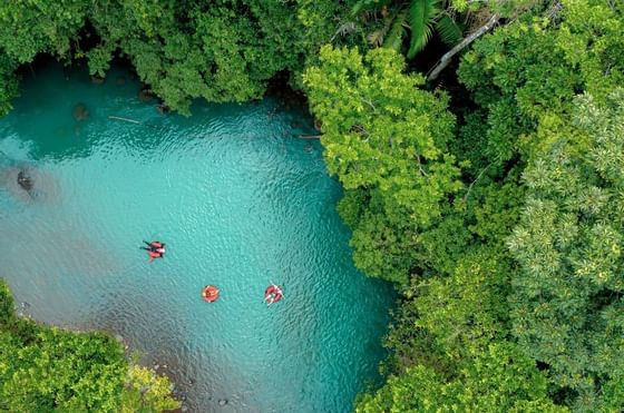 Aerial view of people tubing in the river near Rio Celeste