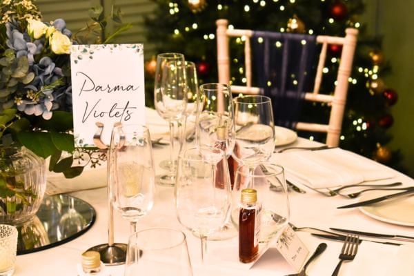 Table set up with Christmas decor by venue in background perfect for a New Years Eve wedding