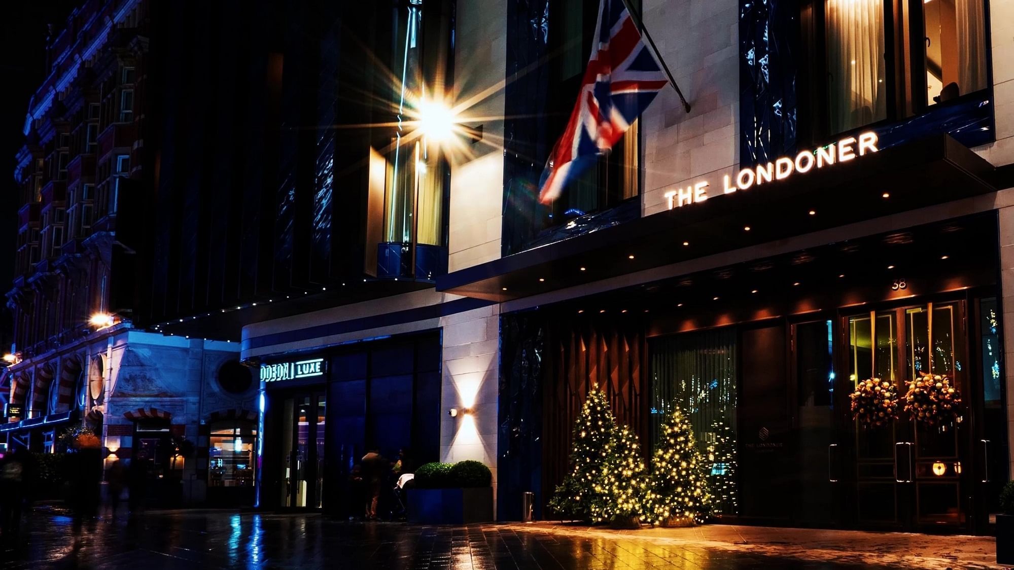 Hotel exterior with night Christmas decorations at The Londoner Hotel