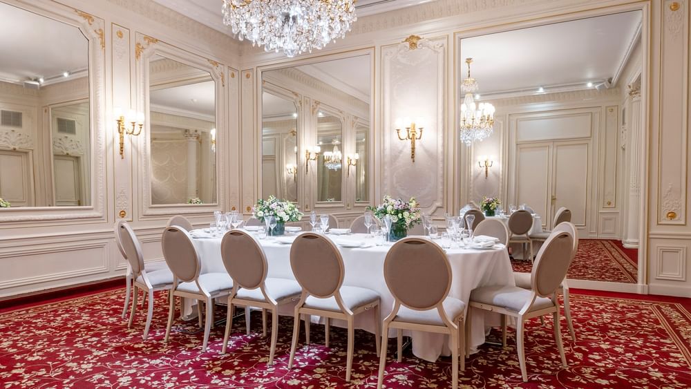 Banquet table, with chairs under a large chandelier in Capucines Meeting Room at Hotel Westminster Paris