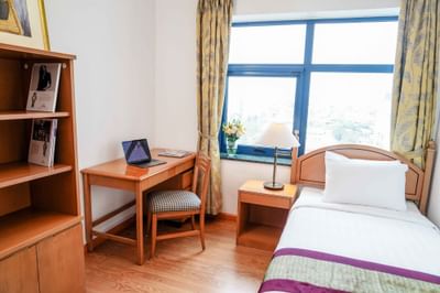 A room with works space and a single bed at Hanoi Daewoo Hotel