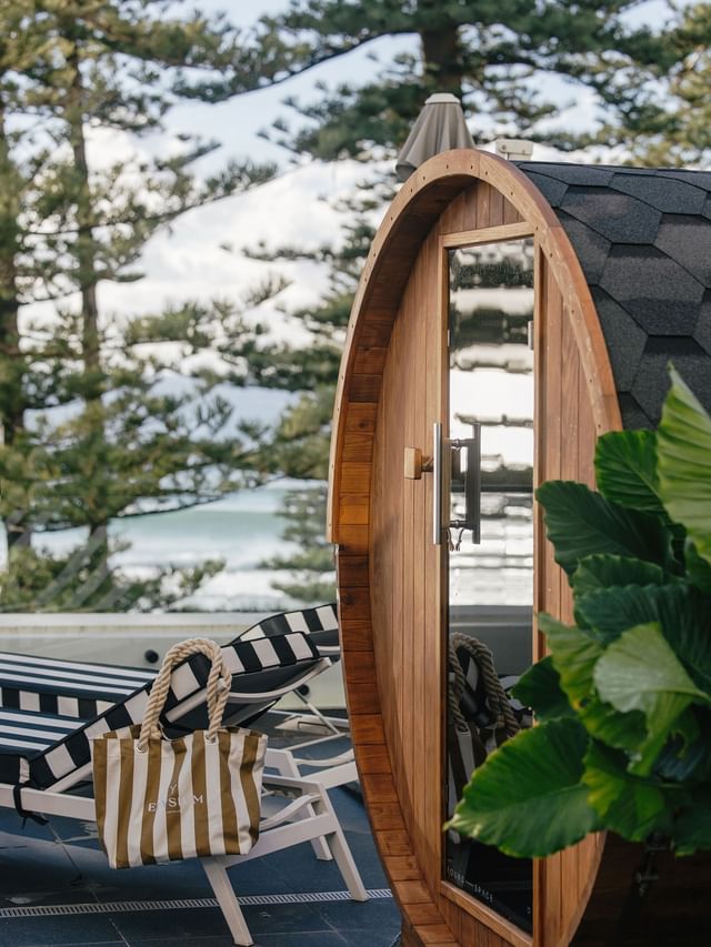 Wellness Suite King at Elysium Hotels with barrel sauna beside striped lounger, showcasing relaxing places to stay in manly